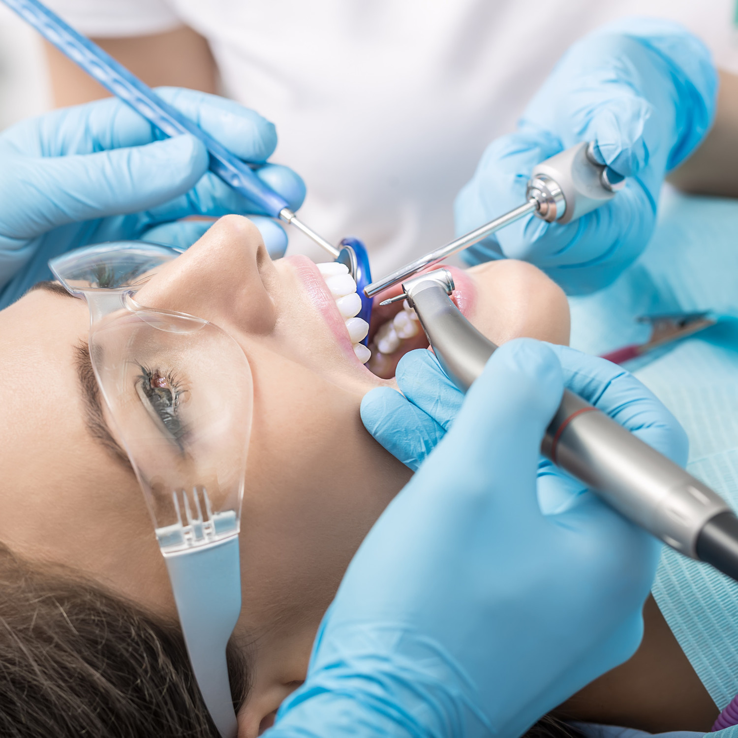 dental, dentistry, dentist, patient, doctor, medical, medicine, clinic, office, equipment, health, healthy, professional, instrument, healthcare, diagnostic, portrait, young, uniform, glove, girl, woman, female, people, care, treatment, bib, mirror, teeth, air, water, syringe, handpiece, protective, glasses, goggles, saliva, ejector, closeup, close-up